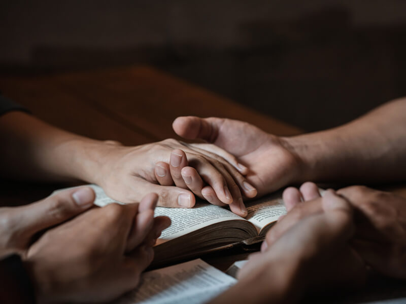 A Group Of Young Christians Holding Hands In Prayer For Faith An